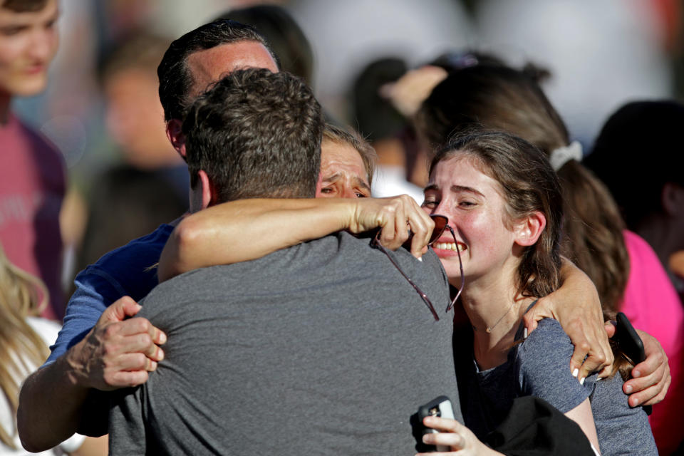 A family reunites outside of Stoneman Douglas High School.