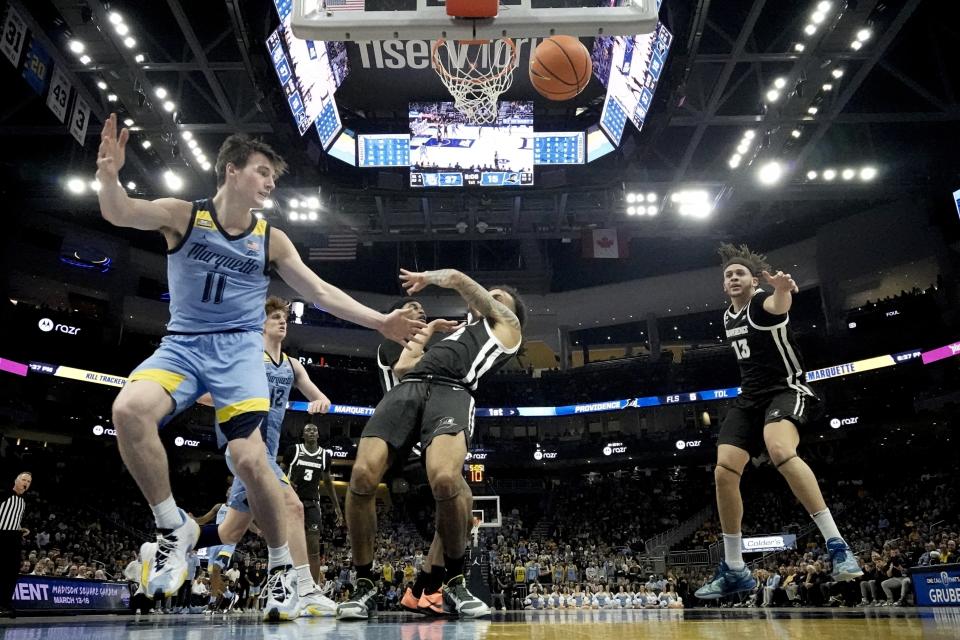 Marquette's Tyler Kolek is fouled by Providence's Devin Carter during the first half of an NCAA college basketball game Wednesday, Feb. 28, 2024, in Milwaukee. (AP Photo/Morry Gash)