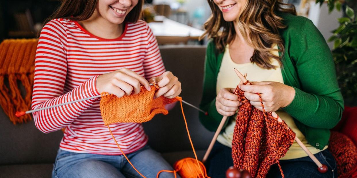 two women knitting together