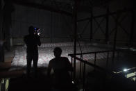 Journalists tour the metal factory near a gas facility where Israeli Prime Minister Benjamin Netanyahu said in a statement that the Hezbollah group is storing missiles close to Beirut's airport in Beirut's southern neighborhood of Jnah, Lebanon, Tuesday, Sept. 29, 2020. Hezbollah denied the allegations and invited media outlets to immediately visit the site, where they found a small factory housing heavy machinery but no evidence of weapons. (AP Photo/Hassan Ammar)