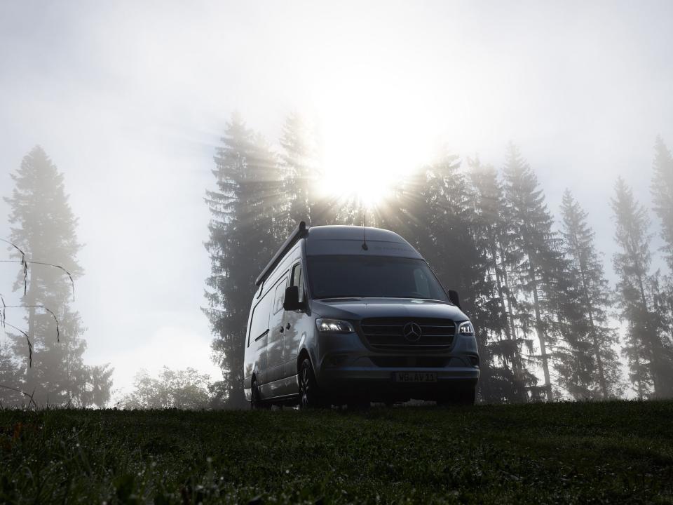 Alphavan's camper van in a grassy field.