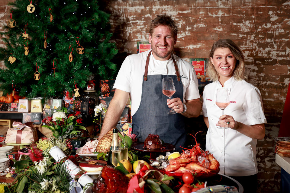 Coles ambassador Curtis Stone and Courtney Roulston with Christmas decorations and food 