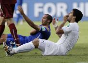 FILE - Uruguay's Luis Suarez holds his teeth after biting Italy's Giorgio Chiellini's shoulder during the group D World Cup soccer match between Italy and Uruguay at the Arena das Dunas in Natal, Brazil, on June 24, 2014. The 21st World Cup gets underway on Thursday, June 14, 2018 in Moscow when host Russia takes on Saudi Arabia. (AP Photo/Ricardo Mazalan, File)