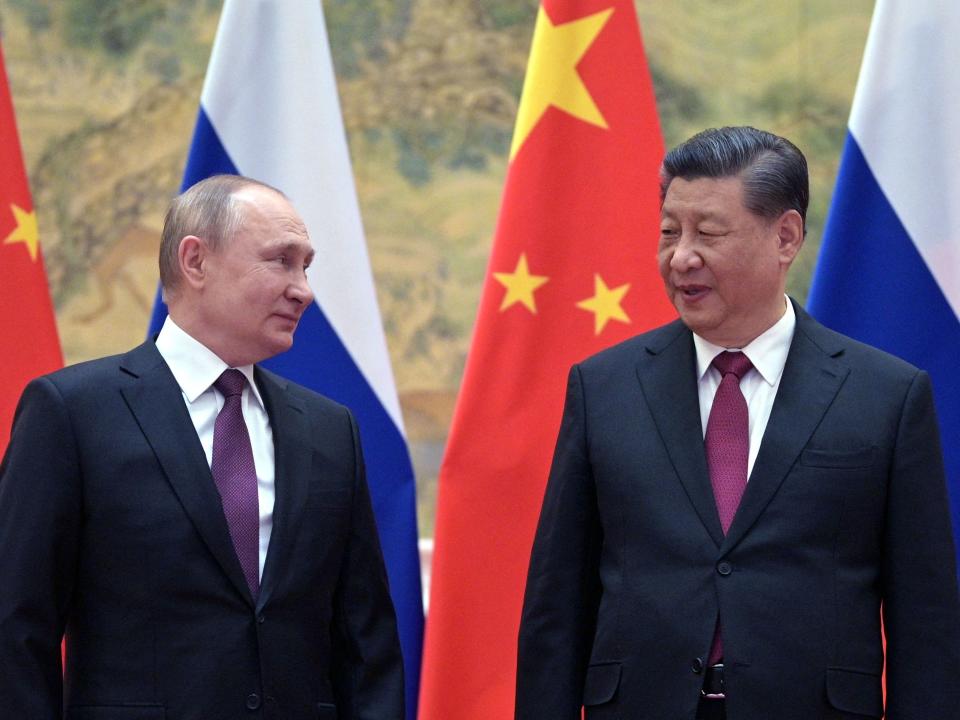 Russian President Vladimir Putin (L) and Chinese President Xi Jinping pose for a photograph during their meeting in Beijing, on February 4, 2022.
