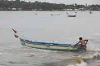 A fisherman pushes his boat to anchor it before cyclone Nisarga makes its landfall, in Mumbai, India June 3, 2020. REUTERS/Francis Mascarenhas