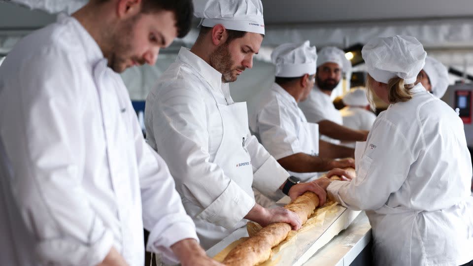 French bakers try not to crack the baguette when it comes out of a large rotating oven. - Stephanie Lecocq/Reuters