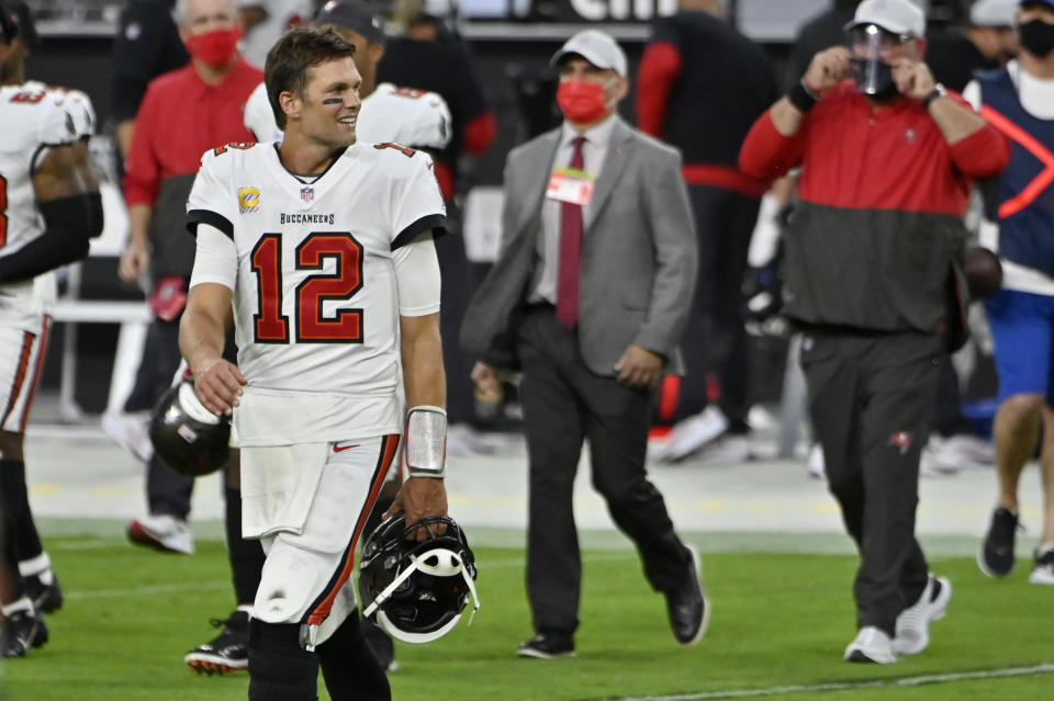 Tampa Bay Buccaneers quarterback Tom Brady (12) walks onto the field after defeating the Las Vegas Raiders in an NFL football game, Sunday, Oct. 25, 2020, in Las Vegas. (AP Photo/David Becker)