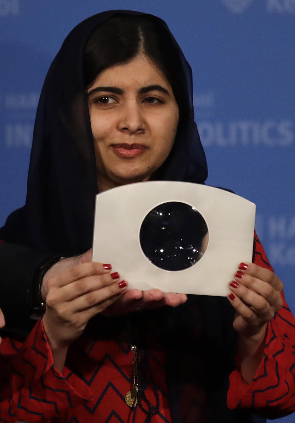 2014 Nobel Laureate Malala Yousafzai holds up the 2018 Gleitsman Activist Award while being honored prior to an address at the Kennedy School's Institute of Politics at Harvard University, Thursday, Dec. 6, 2018. (AP Photo/Charles Krupa)