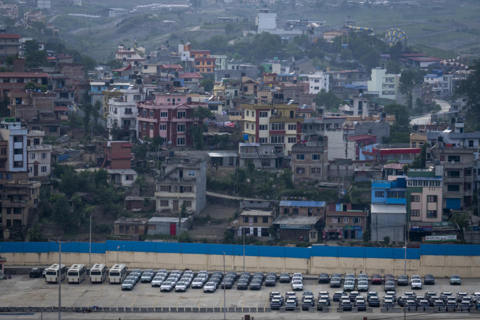 Newly imported electric vehicles are seen parked at the Chobhar Dry Port in Kirtipur, Nepal, Thursday, May 30, 2024. To encourage purchases of EVs, the government is charging lower duties on imported EVs, ranging from 25% to 90%. The import duties on gas and diesel-fueled vehicles are 276% to 329%. (AP Photo/Niranjan Shrestha)