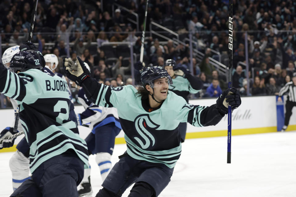 Seattle Kraken left wing Brandon Tanev (13) celebrates after scoring a goal against the Winnipeg Jets during the third period of an NHL hockey game, Sunday, Nov. 13, 2022, in Seattle. (AP Photo/John Froschauer)