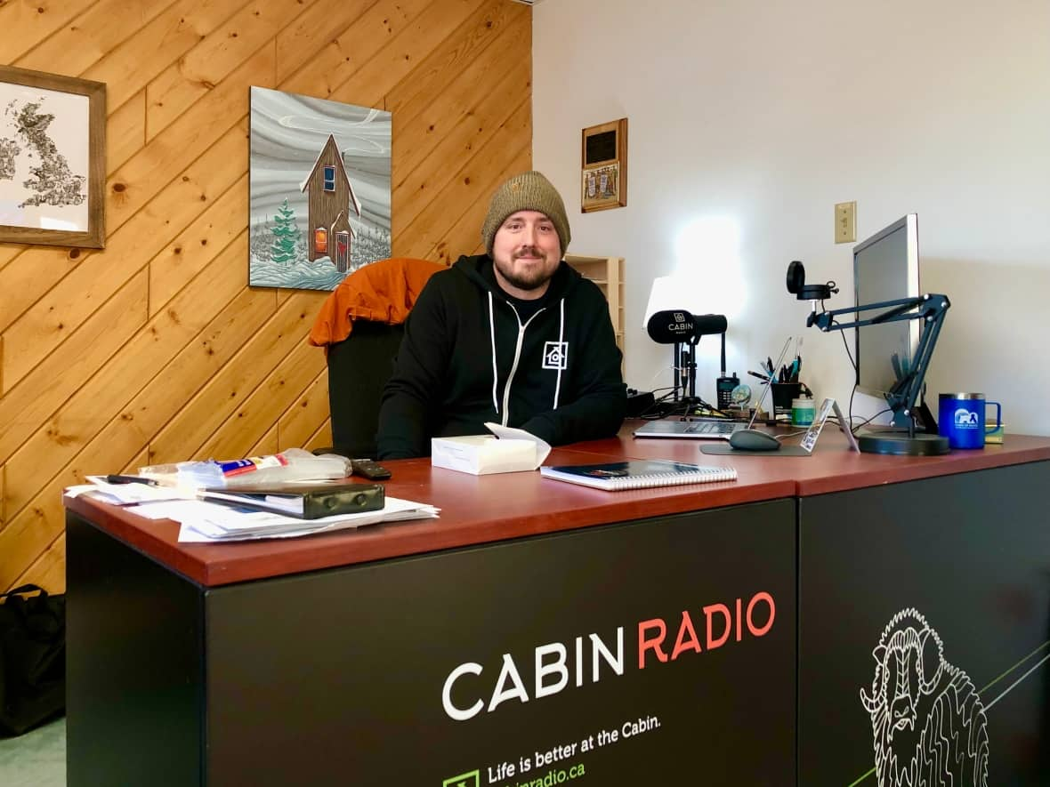 Cabin Radio's editor and part-owner, Ollie Williams, at Cabin Radio's newsroom in Yellowknife. The company applied to the Canadian Radio-television and Telecommunications Commission (CRTC) for a commercial FM licence in August of 2019, but the application has yet to be approved or denied.   (Sidney Cohen/CBC - image credit)