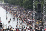 People wade in the Reflecting Pool during the March on Washington, Friday Aug. 28, 2020, at the Lincoln Memorial in Washington, on the 57th anniversary of the Rev. Martin Luther King Jr.'s "I Have A Dream" speech. (AP Photo/Alex Brandon)