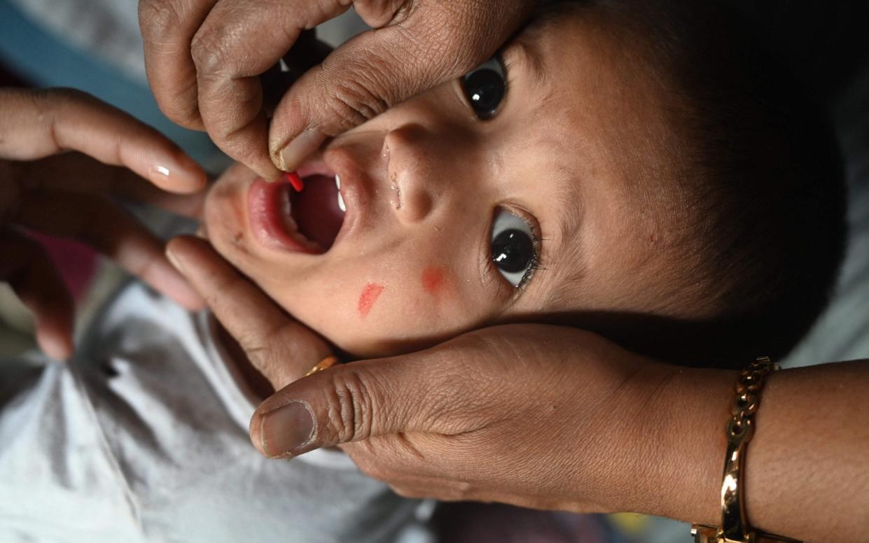 A health worker administers a vaccine to a child at a temporary vaccination camp following a measles outbreak that has caused the death of 10 children, in Mumbai - INDRANIL MUKHERJEE/AFP via Getty Images)