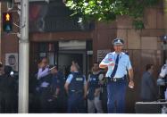 Police maintain a cordon around the cafe