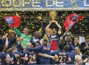 Paris Saint Germain's Thiago Motta, center, of Italy, and teammates celebrate with the cup after winning their French League Cup final soccer match against Lyon at the Stade de France in Saint Denis, north of Paris, Saturday April 19, 2014. (AP Photo/Jacques Brinon)