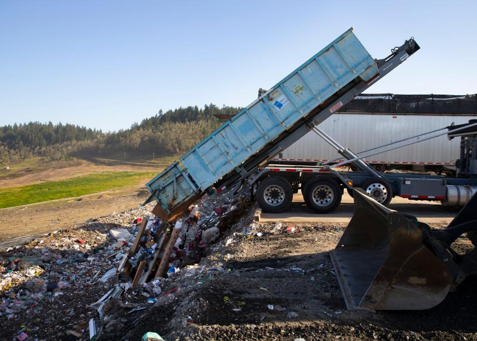 Trucks dump garbage at the Short Mountain Landfill south of Eugene. 