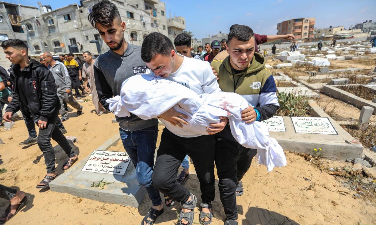 <span>People mourn as they receive the bodies of victims of an Israeli strike on 11 April in Rafah, Gaza.</span><span>Photograph: Ahmad Hasaballah/Getty</span>