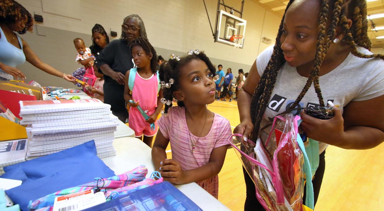 Six-year-old Brenae Crawford picks out school supplies with her mother, Breana Crawford, during the Backpack to School Backpack Giveaway event held Saturday, August 12, 2023, at the Erwin Center in Gastonia.