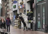 Police patrol the city center after a demonstration against COVID-19 restrictions and lockdown was banned in Nijmegen, eastern Netherlands, Sunday, Nov. 28, 2021. (AP Photo/Peter Dejong)