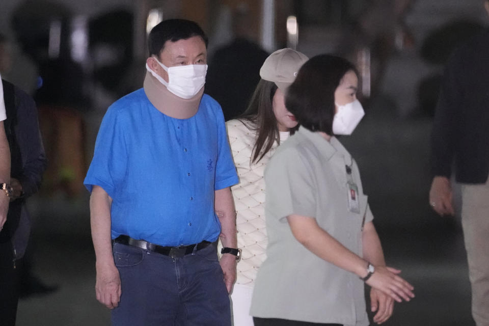 Former Thai Prime Minister Thaksin Shinawatra, center, visits City Pillar Shrine in Bangkok, Thailand, Thursday, March 14, 2024. Earlier in February, he was released on parole from a hospital where he spent six months serving time for corruption-related offenses. (AP Photo/Sakchai Lalit)