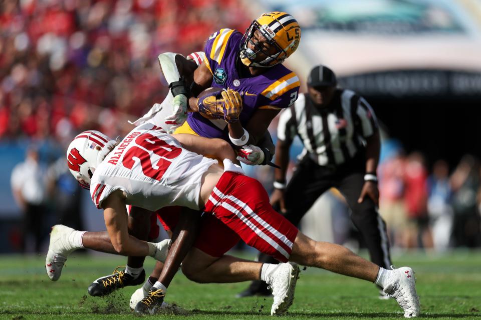 Wisconsin linebacker Christian Alliegro looks to bring down LSU receiver Kyren Lacy after a catch during the ReliaQuest Bowl on Jan 1. Alliegro has been showing his speed at the inside linebacker position during spring practice.