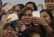 Filipino students take "selfie" with Davao City Mayor Sara Duterte, eldest daughter of Philippine President Rodrigo Duterte, in Davao city in southern Philippines, August 6, 2017. REUTERS/Lean Daval Jr/Files