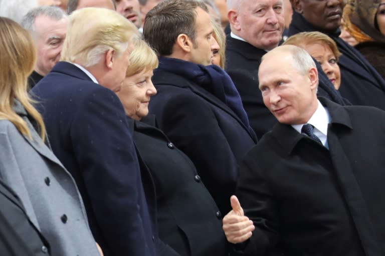 Putin (R) gives Trump a thumbs-up as they attend a ceremony at the Arc de Triomphe in Paris on November 11, 2018 to commemorate the armistice ending World War I