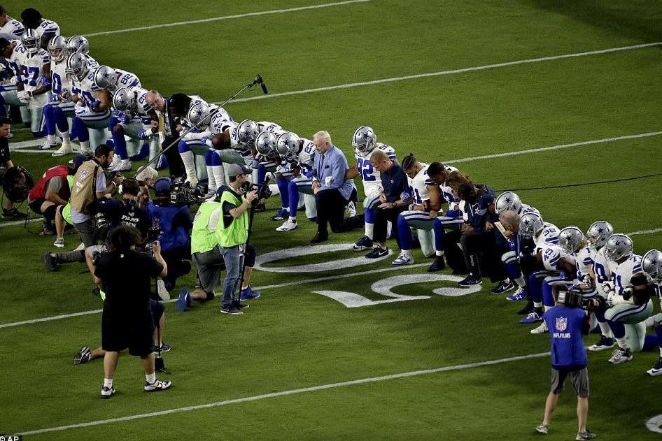 Protest: Pictured is the entire Dallas Cowboys team, including its owner Jerry Jones, (© AP)