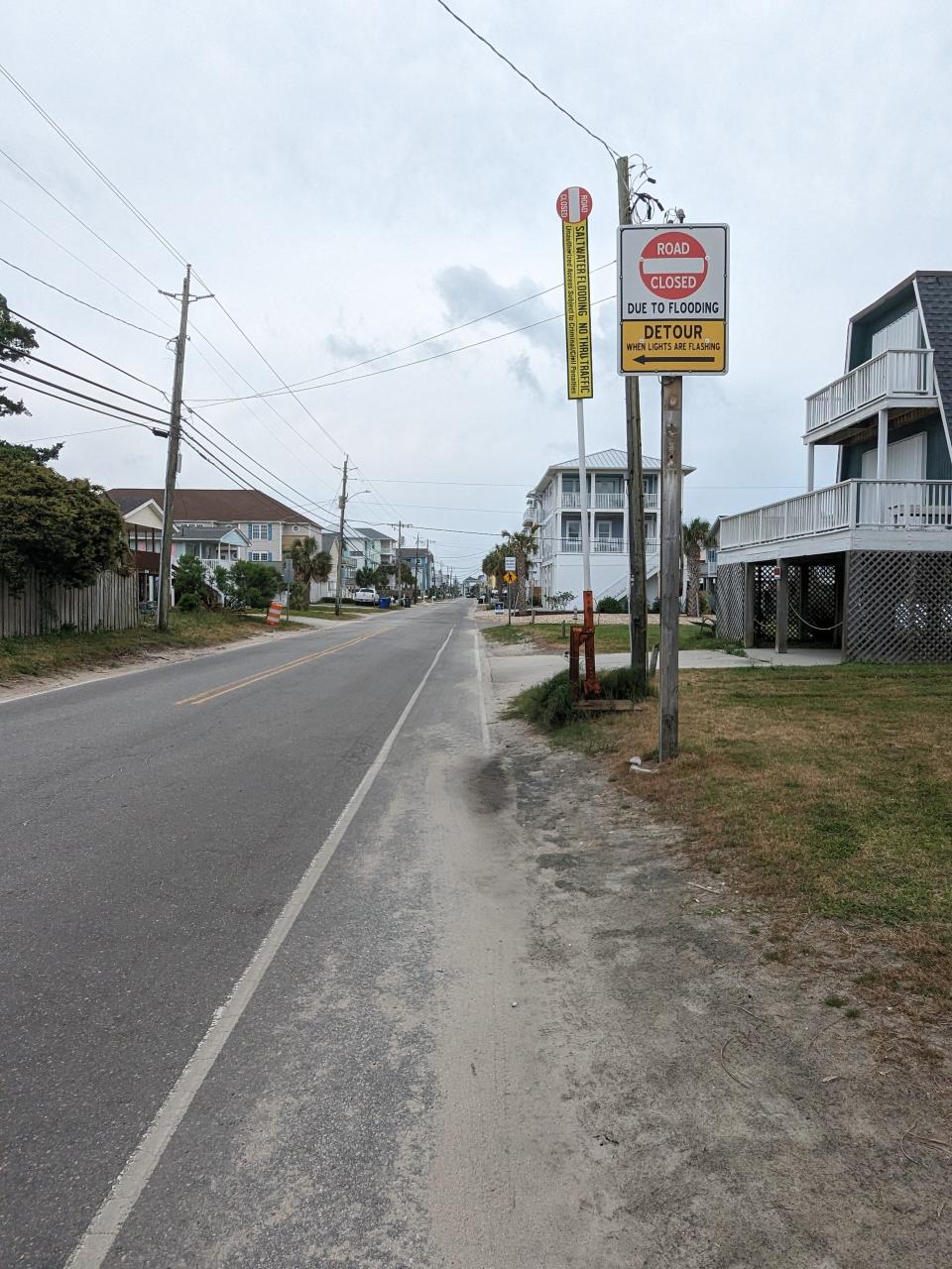 Sign warns drivers that gates will be lowered if Canal Drive floods, detouring them onto Carolina Beach Avenue North.