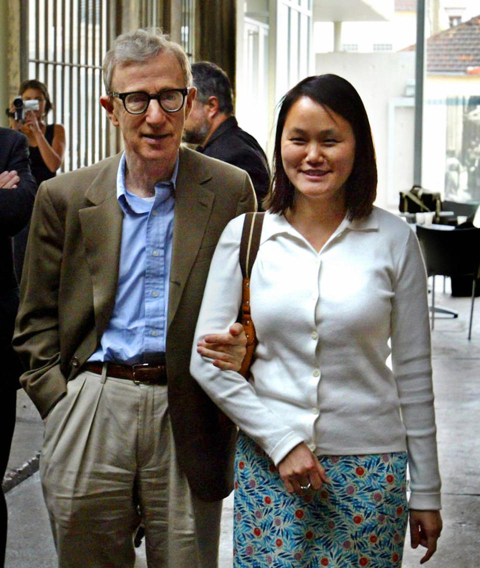 US director Woody Allen poses with his wife Soon-Yi at the Lumiere Institute in Lyon, south of France, during a private visit, hours before his jazz concert at the Vienna antic theatre with the 'New Orleans Jazz Band' 08 September 2003.