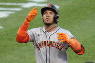 San Francisco Giants' Thairo Estrada celebrates as he crosses home plate after hitting a two-run home run off Pittsburgh Pirates starting pitcher Martín Pérez during the fifth inning of a baseball game in Pittsburgh, Tuesday, May 21, 2024. (AP Photo/Gene J. Puskar)