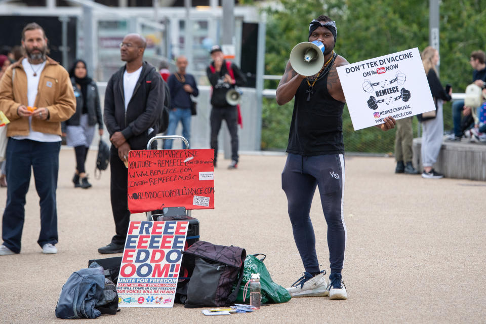 An anti vaccination protestor outside an NHS Vaccination Clinic at West Ham's London Stadium in Stratford, east London. The NHS is braced for high demand as anyone in England over the age of 18 can now book a Covid-19 vaccination jab. Picture date: Saturday June 19, 2021.