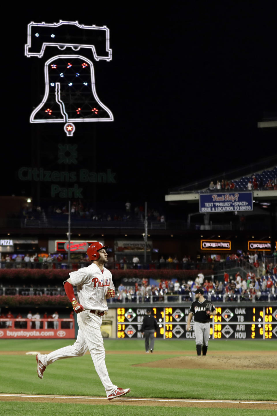 Philadelphia Phillies' Mitch Walding, left, rounds the bases after hitting a two-run home run off Miami Marlins relief pitcher Bryan Holaday during the eighth inning of a baseball game, Friday, Sept. 14, 2018, in Philadelphia. (AP Photo/Matt Slocum)