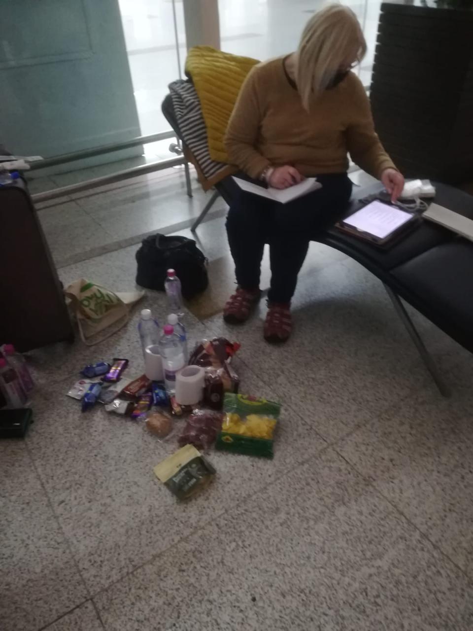 The women are sleeping in the airport terminal and eating snacks. (Picture: Diane Want)