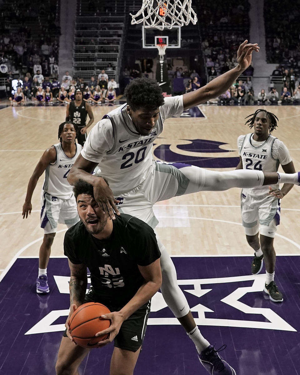 North Alabama forward Damian Forrest (33) looks to shoot under pressure from Kansas State forward Jerrell Colbert (20) during the first half of an NCAA college basketball game Saturday, Dec. 2, 2023, in Manhattan, Kan. (AP Photo/Charlie Riedel)