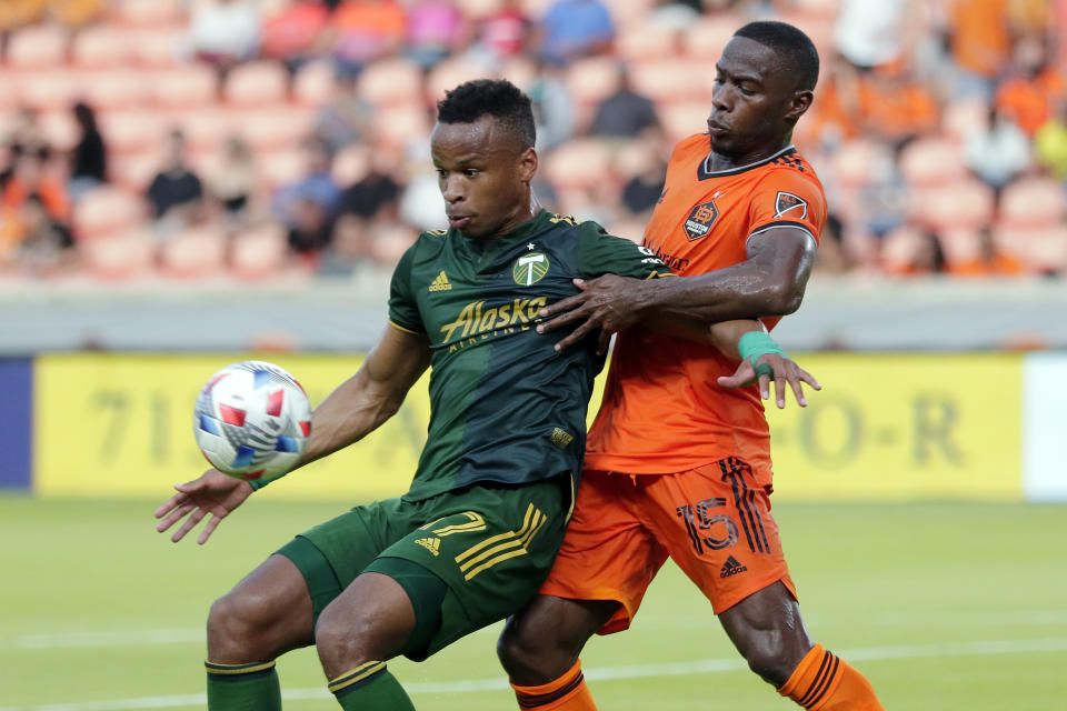 Portland Timbers forward Jeremy Ebobisse (17) blocks out Houston Dynamo defender Maynor Figueroa (15) as he brings the ball down during the first half of an MLS soccer match Wednesday, June 23, 2021, in Houston. (AP Photo/Michael Wyke)