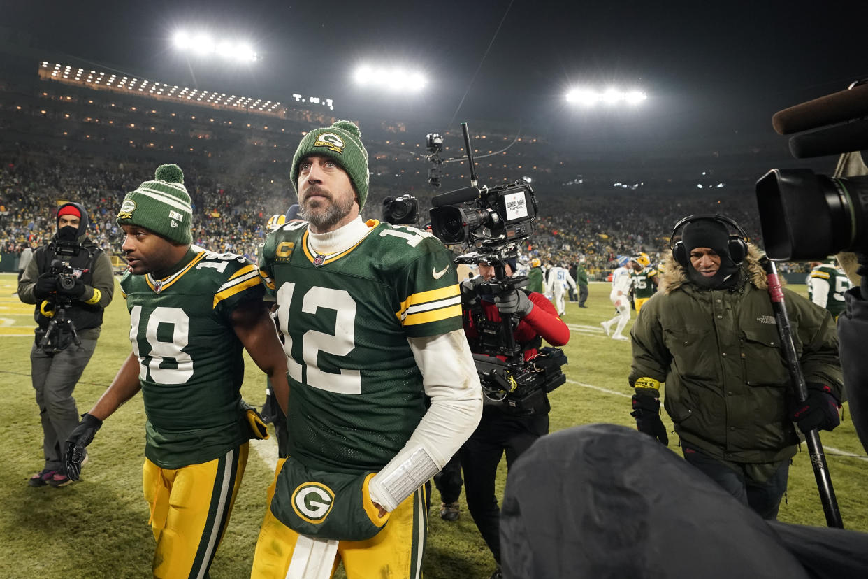 GREEN BAY, WISCONSIN - JANUARY 08: Aaron Rodgers #12 and Randall Cobb #18 of the Green Bay Packers walk off the field after losing to the Detroit Lions at Lambeau Field on January 08, 2023 in Green Bay, Wisconsin. (Photo by Patrick McDermott/Getty Images)