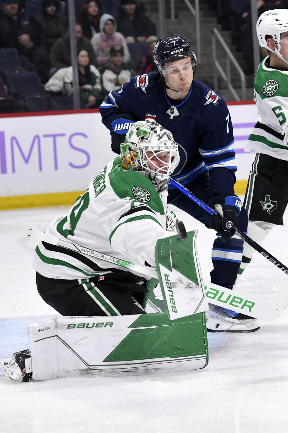 Dallas Stars goaltender Jake Oettinger (29) makes a save as Winnipeg Jets' Vladislav Namestnikov (7) looks for the rebound during the second period of an NHL hockey match in Winnipeg, Manitoba, on Tuesday, Nov. 28, 2023. (Fred Greenslade/The Canadian Press via AP)