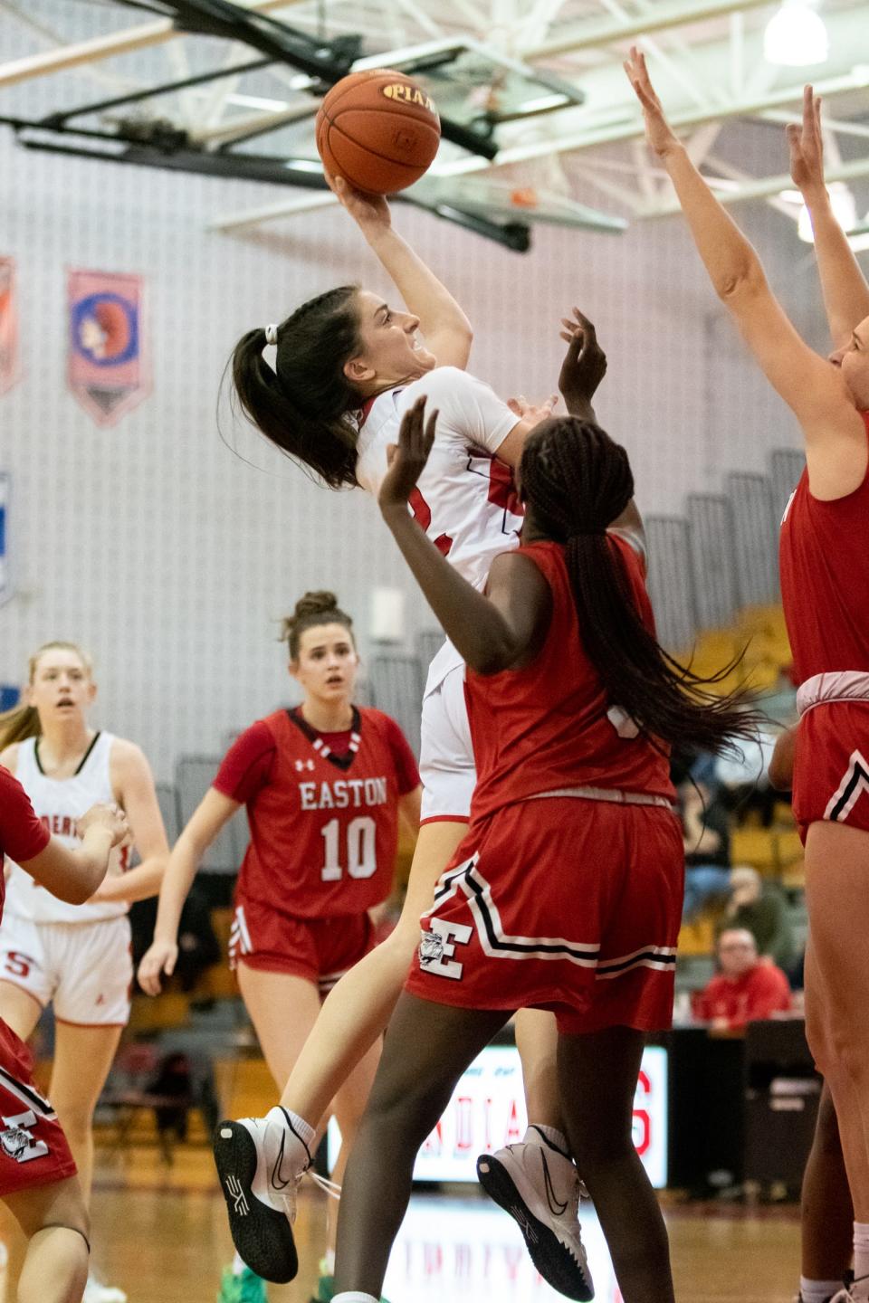 Souderton's Casey Harter shoots while covered by Easton's Sara Tamoun in a PIAA 6A first round state playoff game, on Tuesday, March 8, 2022, at Souderton High School. The Red Rovers defeated Big Red 42-36 to advance to the second round.