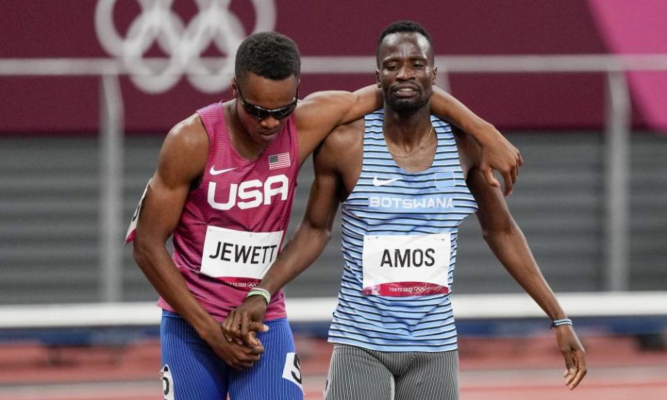 Isaiah Jewett, of the United States, and Nijel Amos, right, of Botswana, shake hands after falling in the men’s 800m semi-final.