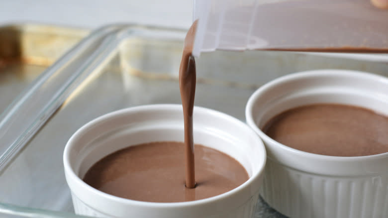 pouring chocolate custard in ceramic cups