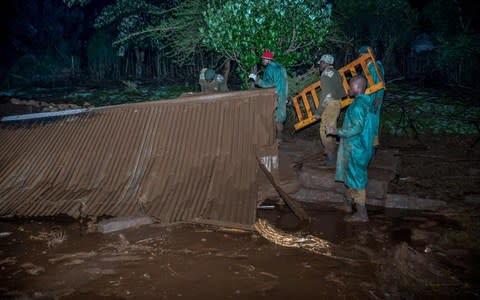 Volunteers search for survivors of the disaster - Credit: AFP