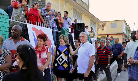 FILE PHOTO: Cuba's First Vice-President Miguel Diaz-Canel stands in line with his wife Lis Cuesta and local residents before casting his vote during an election of candidates for the national and provincial assemblies, in Santa Clara, Cuba March 11, 2018. Alejandro Ernesto/Pool via REUTERS/File Photo