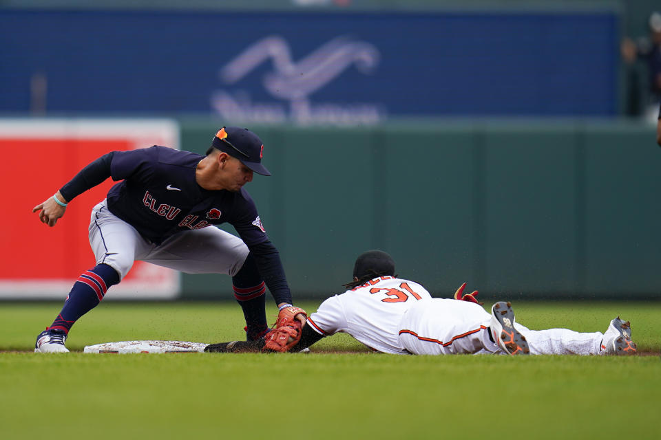 Cleveland Guardians second baseman Andres Gimenez, left, tags out Baltimore Orioles' Cedric Mullins trying to steal second base during the first inning of a baseball game, Monday, May 29, 2023, in Baltimore. (AP Photo/Julio Cortez)