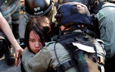 An anti-government protester is detained during a march in Tuen Mun, Hong Kong