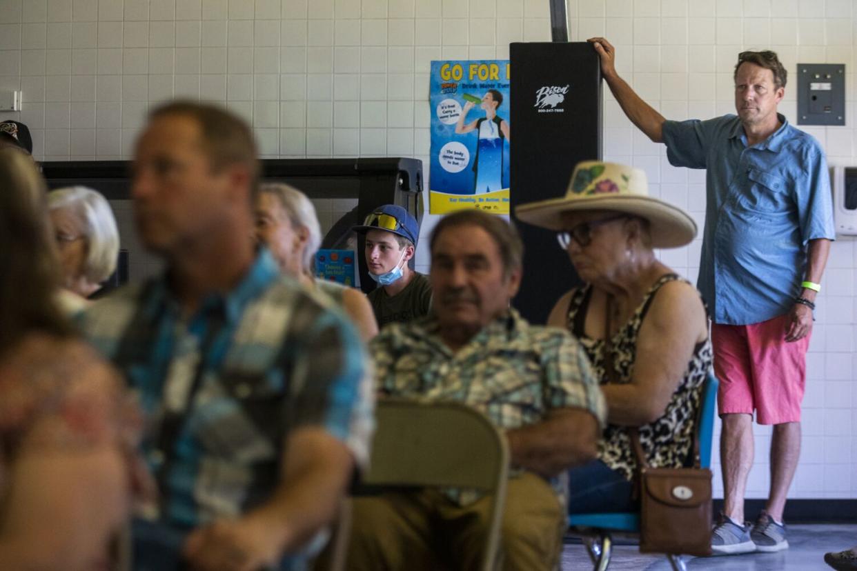 Plumas County Supervisor Kevin Goss, right, listens during a town hall meeting at the high school in Greenville.