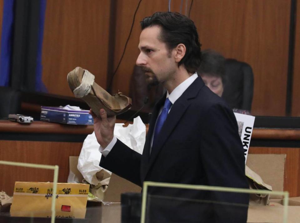 Prosecutor Dan Goldberg shows a shoe worn by Samantha Josephson during the trial of Nathaniel Rowland on Tuesday July 27, 2021 in Richland County Circuit Court. Rowland is accused of killing Samantha Josephson after luring her into his car.