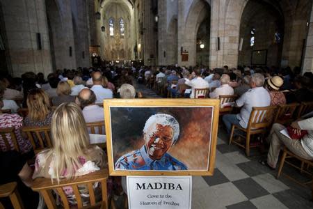 People attend a special Sunday morning service dedicated to Nelson Mandela at St. George's Cathedral in Cape Town December 8, 2013. REUTERS/Mark Wessels