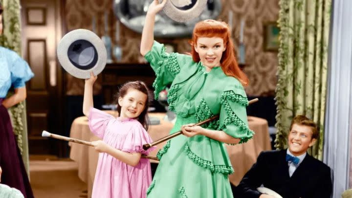 Judy Garland as Esther dancing with her sister at a party in Meet Me in St. Louis.