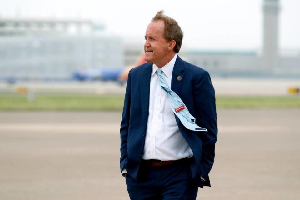 FILE - In this June 28, 2020 file photo, Texas’ Attorney General Ken Paxton waits on the flight line for the arrival of Vice President Mike Pence at Love Field in Dallas. (AP Photo/Tony Gutierrez, File)